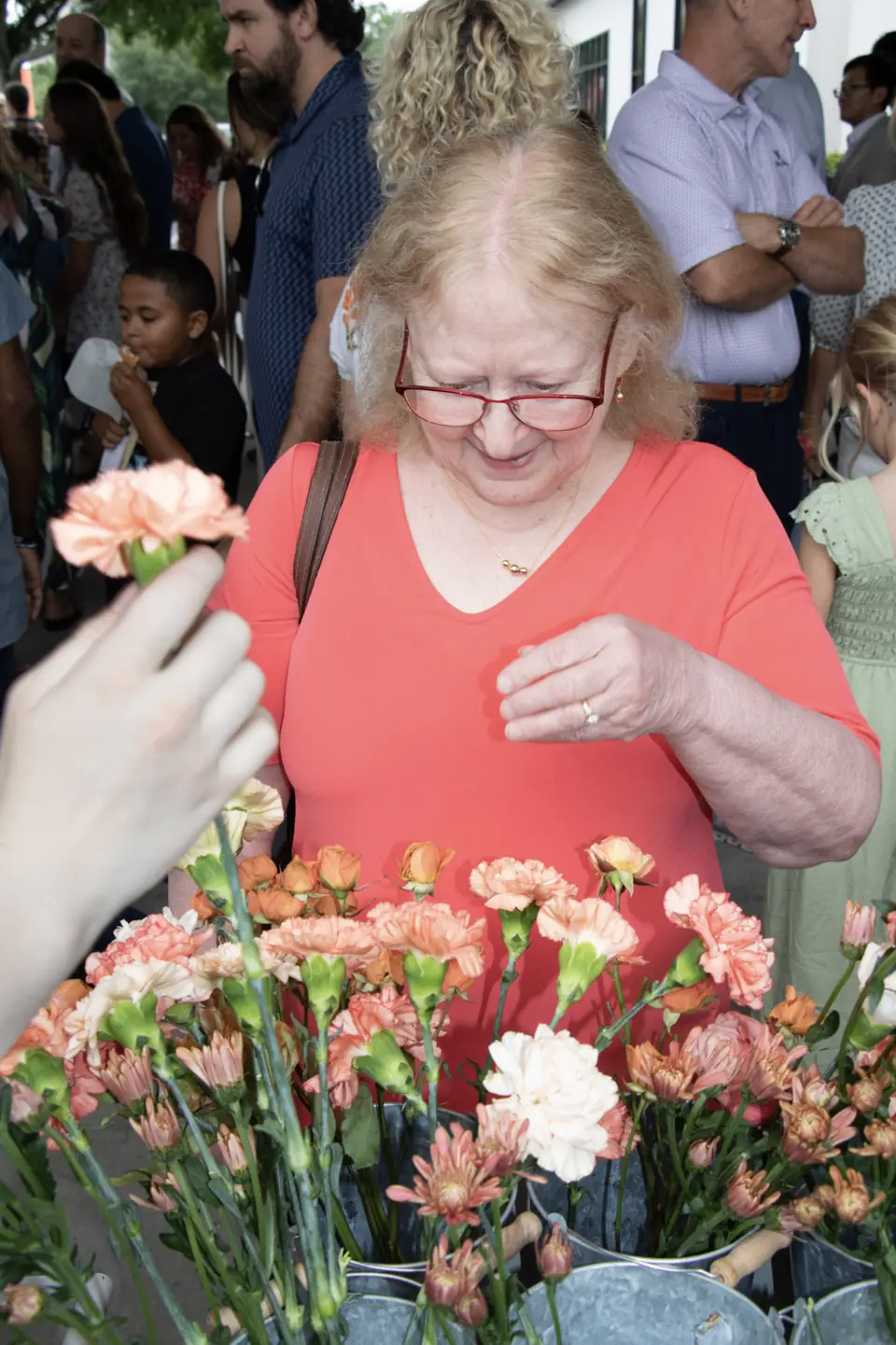 Guest choosing blooms at a community event