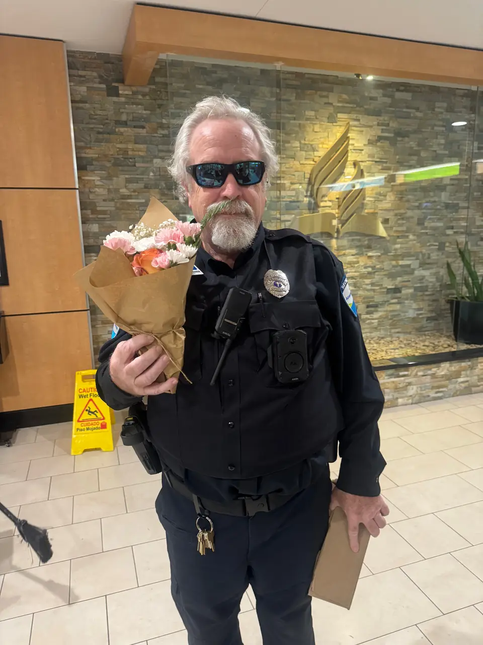 Employee appreciation: a security officer with his bouquet