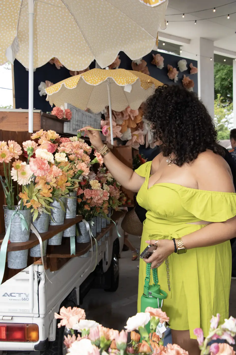 Guest choosing blooms at an outdoor event